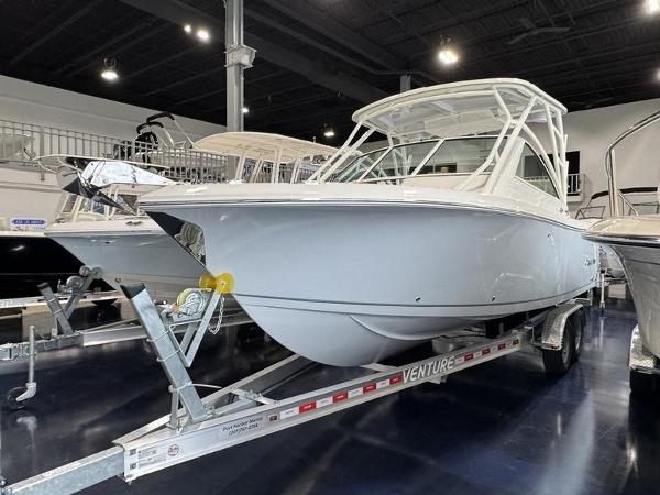 Sailfish 245 DC 2025 Sailfish 245 DC boat on trailer in showroom.