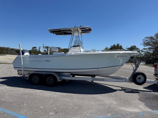 Sea Hunt Triton 220 2009 Sea Hunt Triton 220 boat on trailer under clear blue sky.