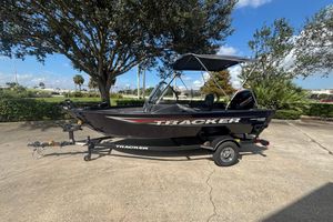 Tracker Pro Guide V-16 WT 2026 Tracker Pro Guide V-16 WT boat on trailer, parked outdoors under a tree.