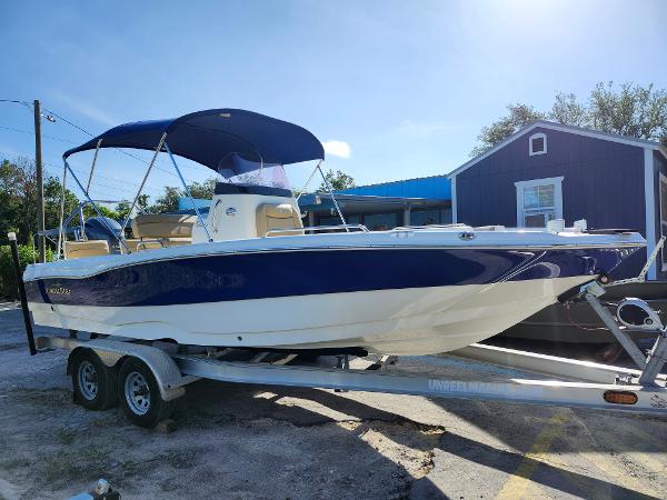 NauticStar 211 Hybrid 2020 NauticStar 211 Hybrid boat on trailer, blue and white design, parked outdoors.