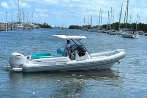 Ranieri CAYMAN 27.0 SPORT TOURING 2025 Ranieri CAYMAN 27.0 SPORT TOURING boat cruising in a marina with sailboats in the background.