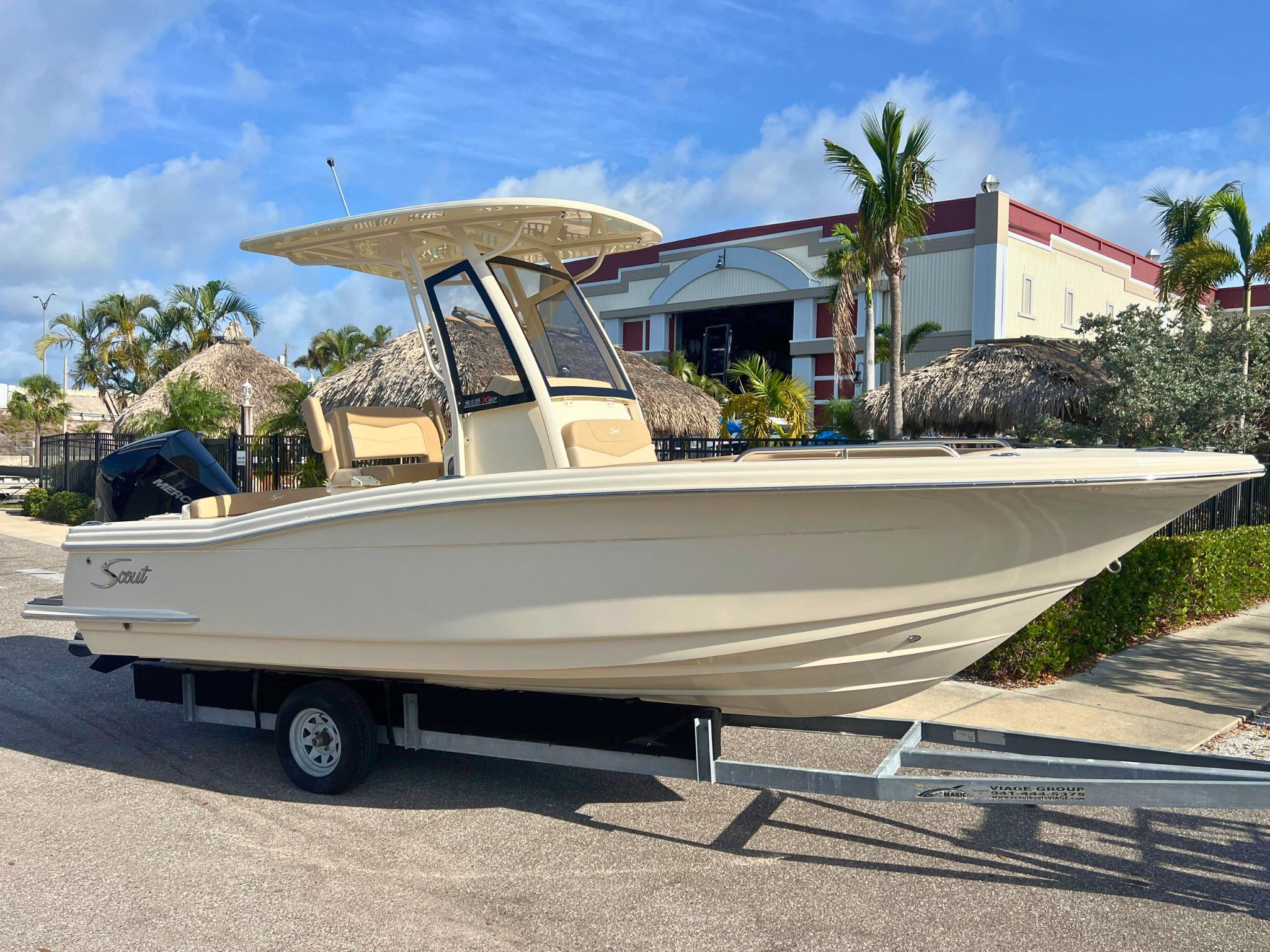 Scout 215 XSF 2025 Scout 215 XSF boat on trailer, parked outdoors under clear sky.