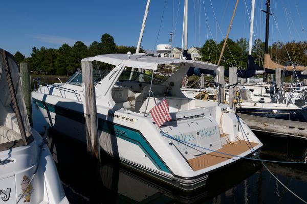Regal Commodore 402 1992 Regal Commodore 402 yacht docked at marina with American flag.