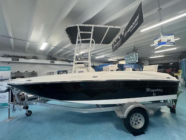 Bayliner Trophy T18 2025 Bayliner Trophy T18 boat displayed in showroom on trailer.