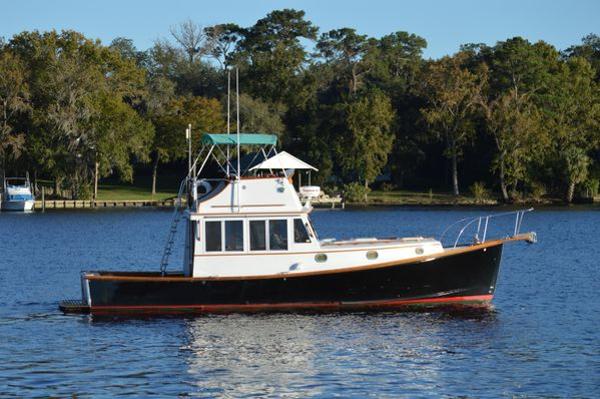 Stanley 36' Downeast Fly Bridge Cruise 1990 Stanley 36' Downeast Fly Bridge Cruise boat on a serene lake.