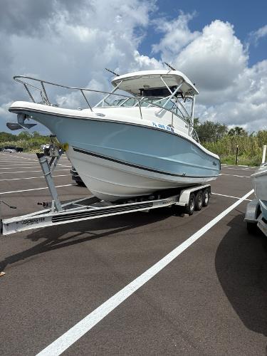 Triton 2690 WA 2003 Triton 2690 WA boat on trailer under cloudy sky.
