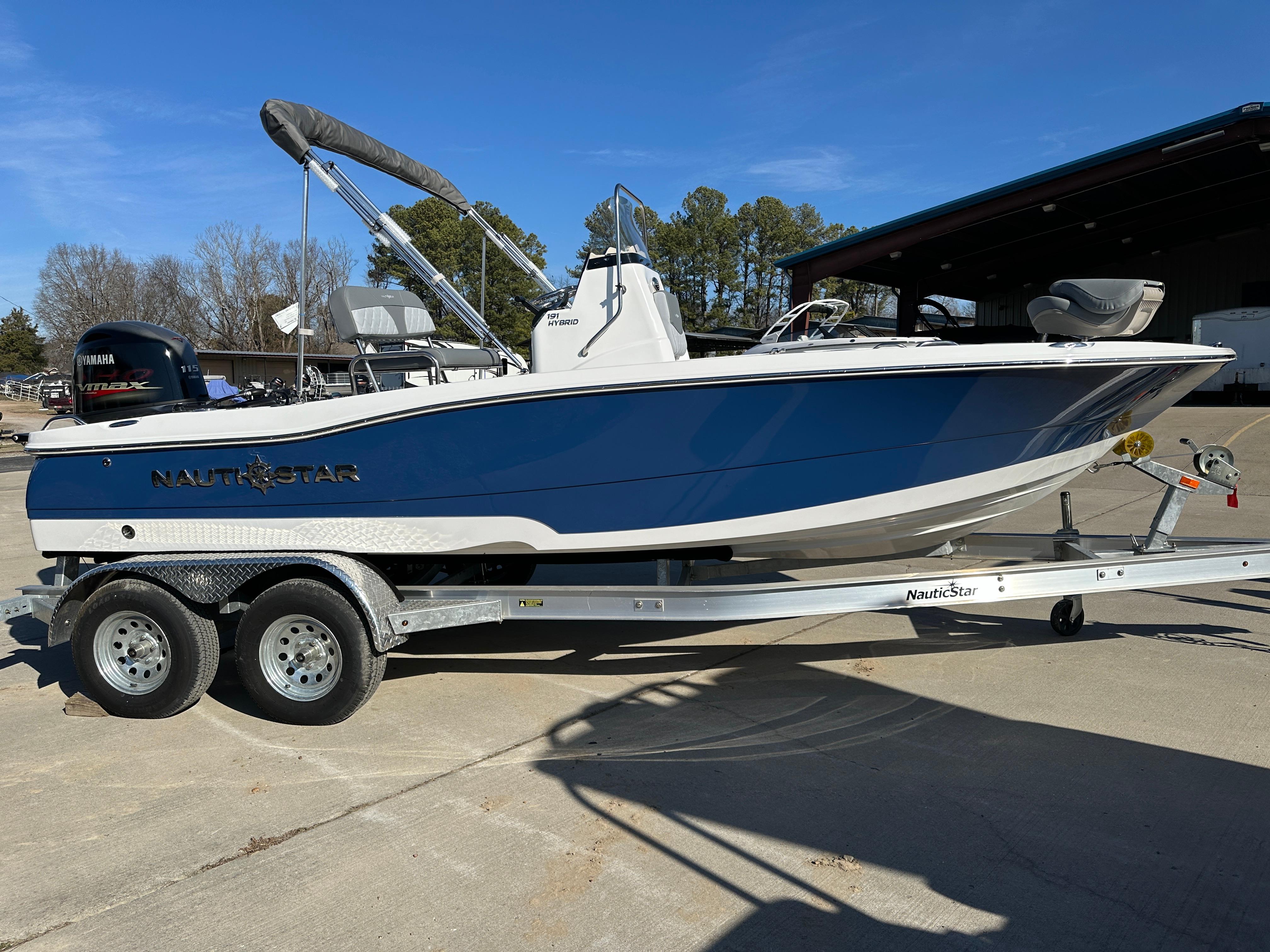 NauticStar 191 Hybrid 2024 NauticStar 191 Hybrid boat on trailer, blue and white design, parked outdoors.