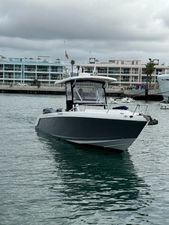 Donzi 35 ZR 2020 Donzi 35 ZR boat on water near modern waterfront buildings.