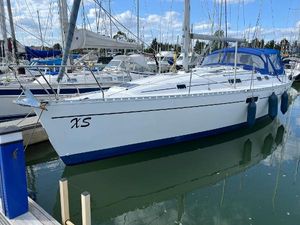 Beneteau Oceanis 351 1998 Beneteau Oceanis 351 sailboat docked in marina, featuring blue accents and protective canopy.