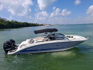 Sea Ray 290 Sundeck Outboard 2016 Sea Ray 290 Sundeck Outboard boat on calm water under a blue sky.