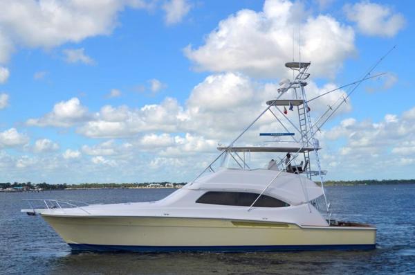Bertram 570 Convertible 2004 Bertram 570 Convertible yacht on calm water under a partly cloudy sky.