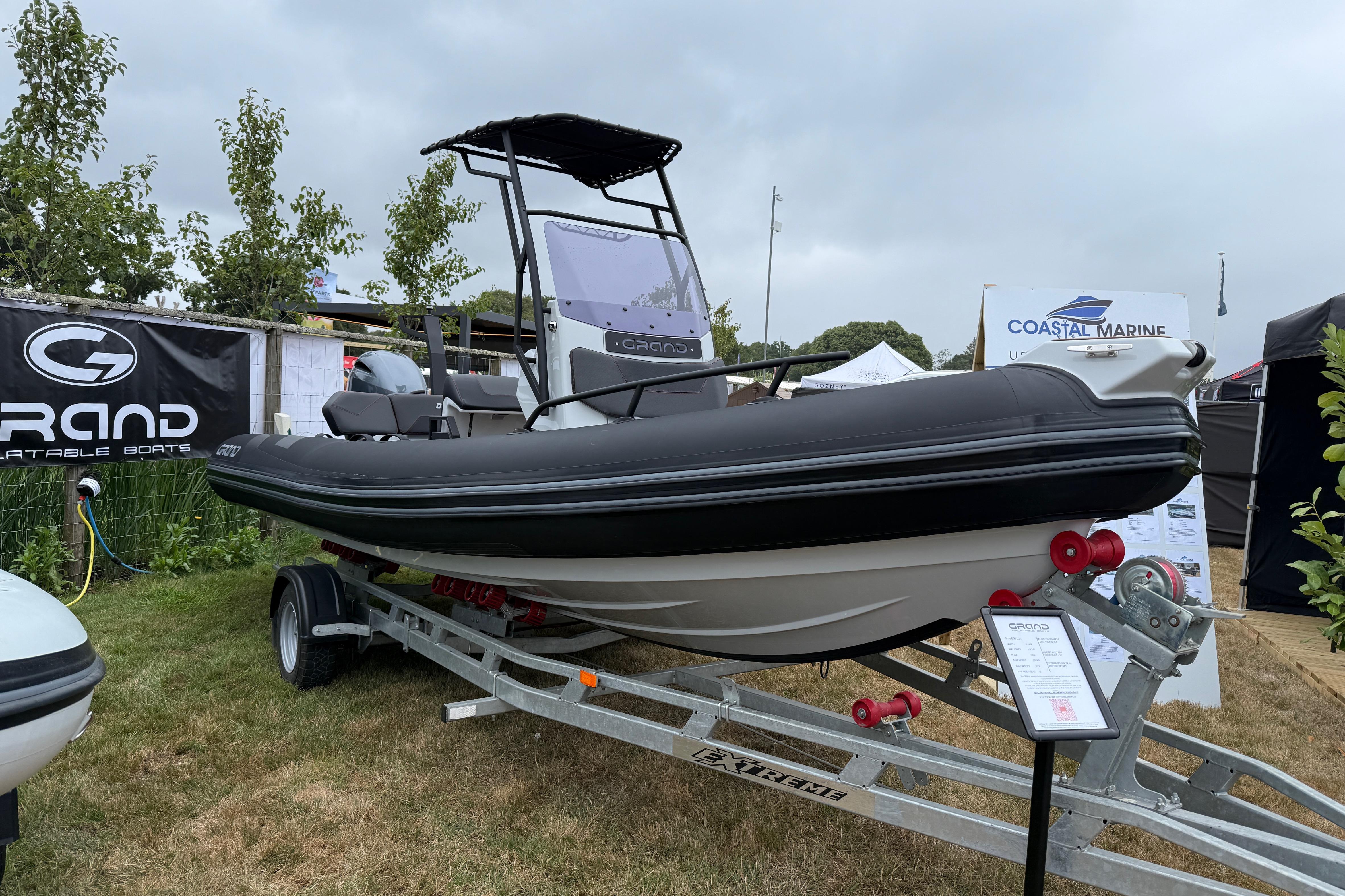 Grand Drive 600 Lux 2025 Grand Drive 600 Lux inflatable boat on trailer at outdoor display.