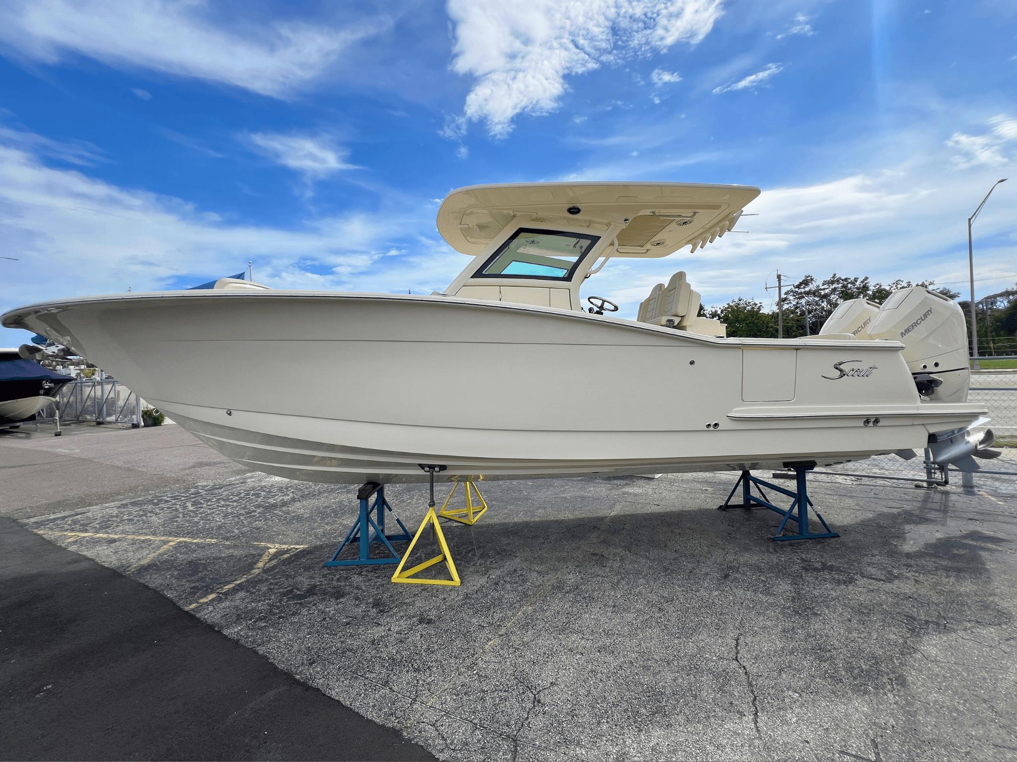 Scout 305 LXF 2025 Scout 305 LXF boat on stands under a clear blue sky.