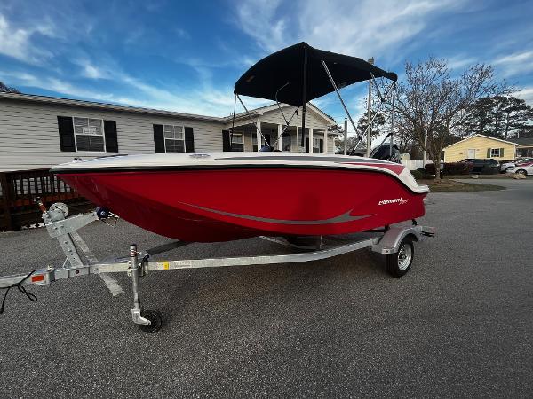 Bayliner Element M15 2024 Bayliner Element M15 boat on a trailer in a residential area.