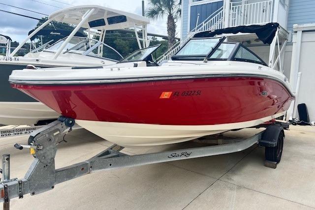 Sea Ray 19 SPX OB 2018 Sea Ray 19 SPX OB boat in red on a trailer, parked outdoors.