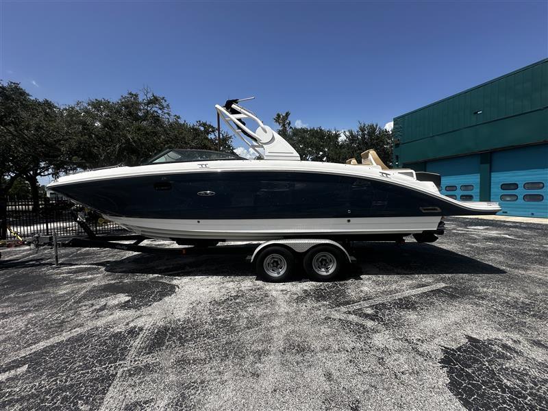 Sea Ray SDX 290 2019 Sea Ray SDX 290 boat on trailer, parked outdoors near a building.