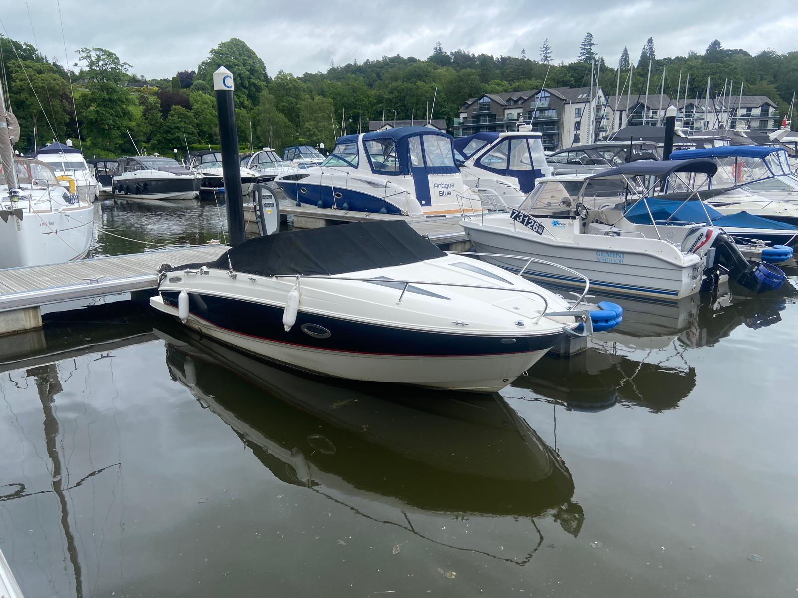 Bayliner 642 Cuddy 2014 Bayliner 642 Cuddy boat docked at a marina, surrounded by other vessels.