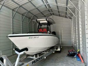 Concept 27' Open Deck 2025 Concept 27' Open Deck boat in metal storage shed on trailer.