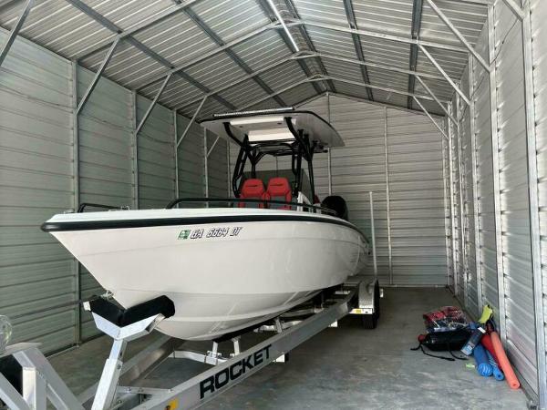 Concept 27' Open Deck 2025 Concept 27' Open Deck boat in metal storage shed on trailer.