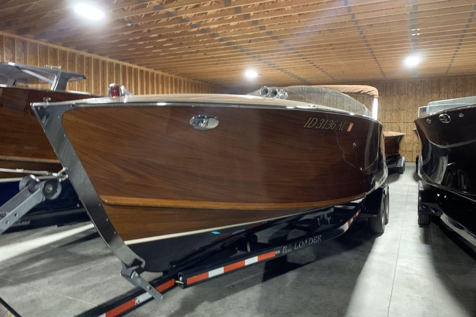 Stancraft 32 Deluxe 2008 StanCraft 32 Deluxe wooden boat in storage, showcasing elegant craftsmanship.