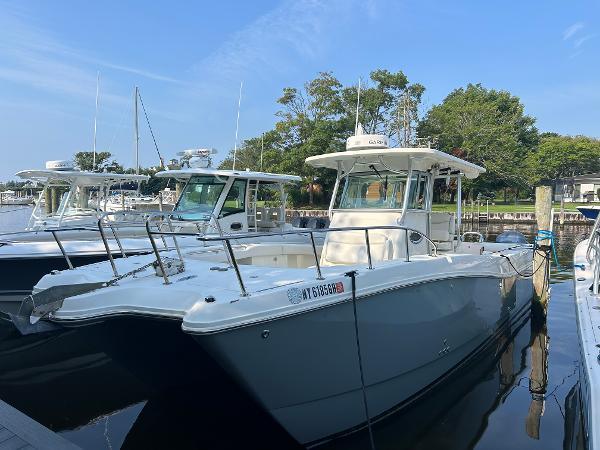 World Cat 320 CC 2012 World Cat 320 CC boat docked in a marina, surrounded by trees.