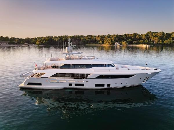 Custom Line Navetta 37 Luxury yacht Custom Line Navetta 37, 2022 model, on serene water at sunset.