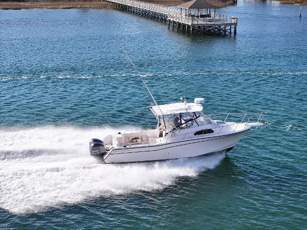 Grady-White Marlin 300 2002 Grady-White Marlin 300 boat cruising on a sunny day near a dock.
