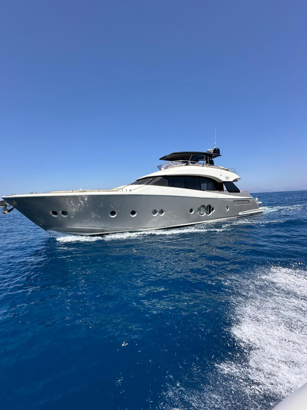 Monte Carlo Yachts MCY 76 Luxurious 2019 Monte Carlo Yachts MCY 76 cruising on clear blue waters.
