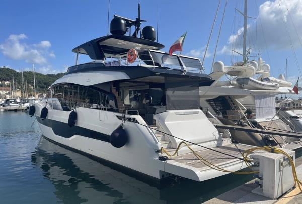 Cranchi settantotto 78 Luxury 2022 Cranchi Settantotto 78 yacht docked at marina under clear blue sky.
