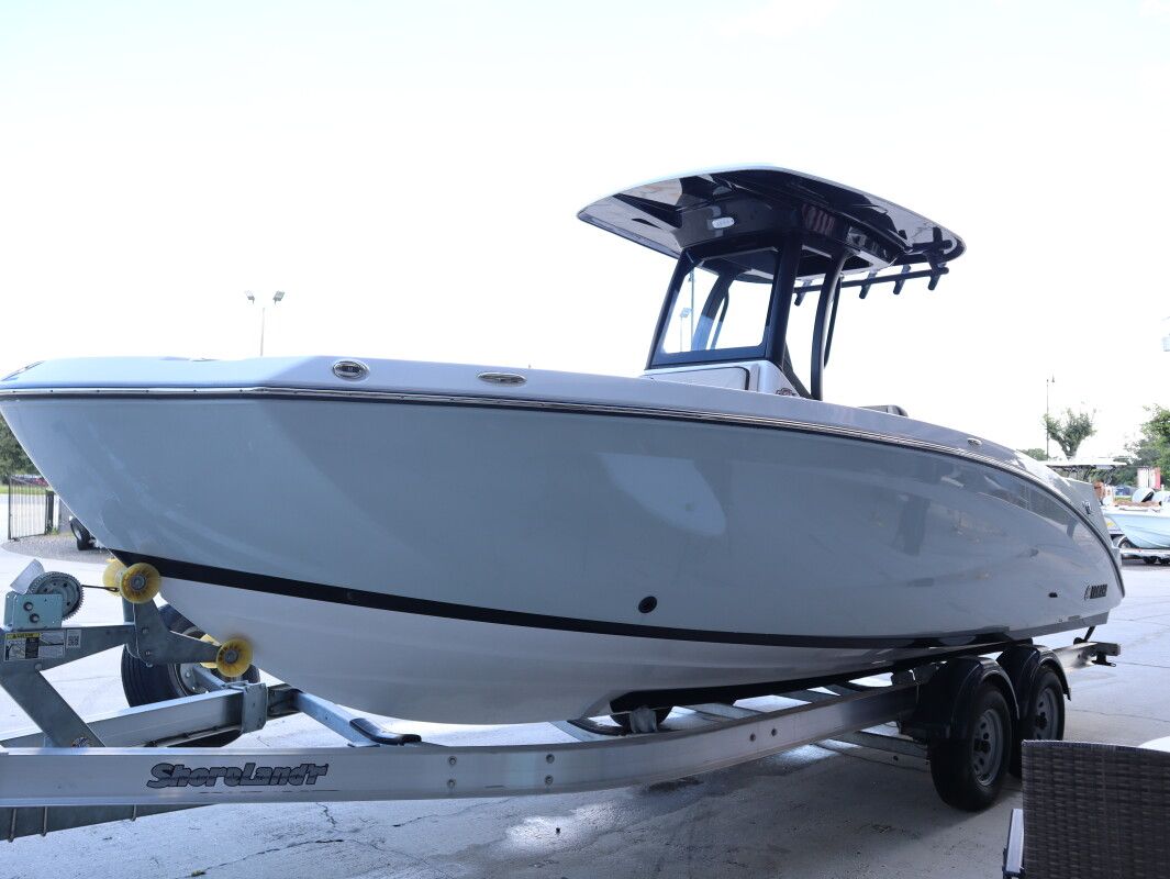 Yamaha Boats 255 FSH Sport E 2024 Yamaha Boats 255 FSH Sport E on trailer, sleek design, outdoor setting.