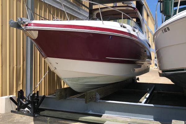 Chaparral 290 Signature 2013 Chaparral 290 Signature boat in storage, red and white exterior.