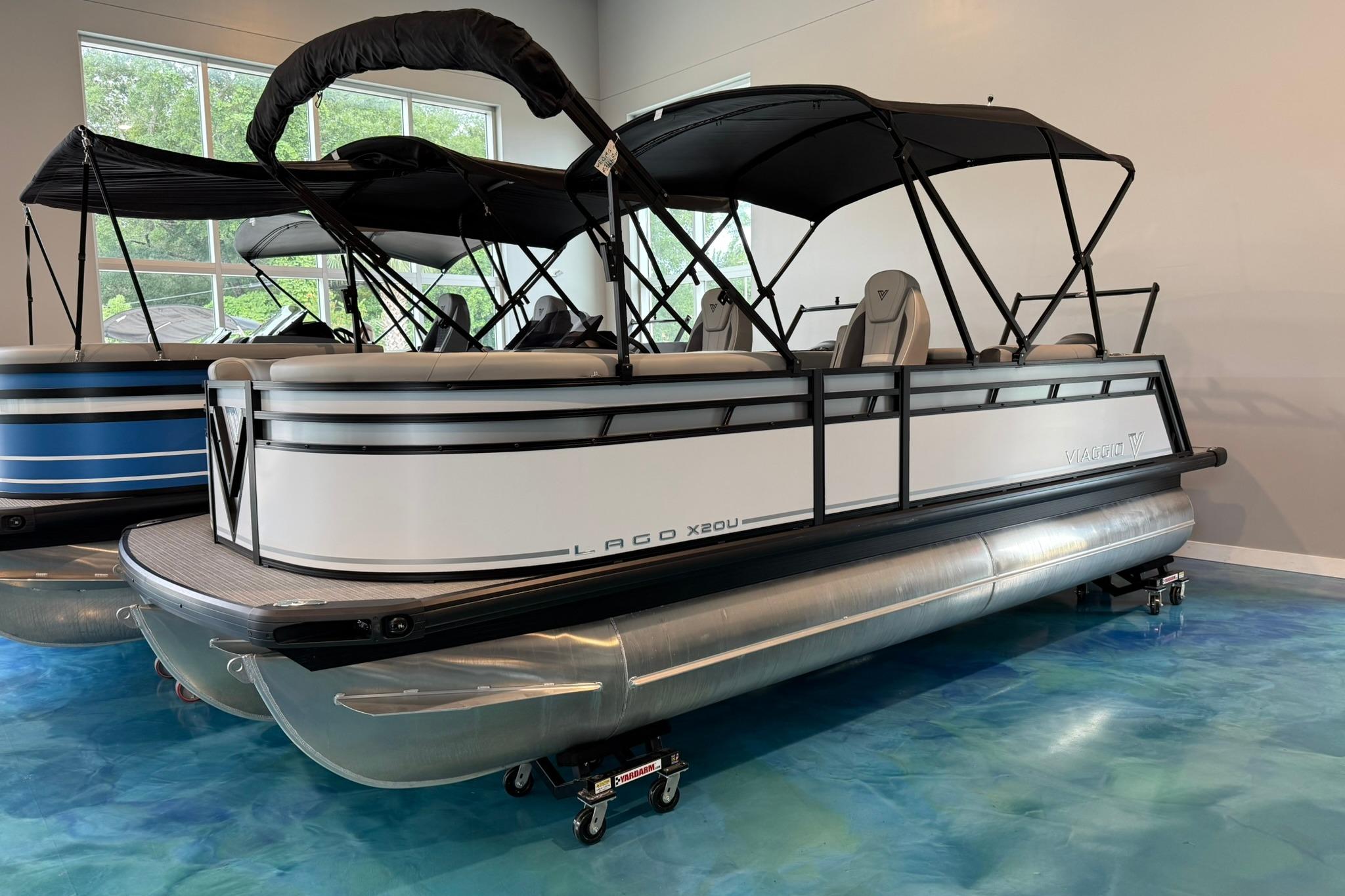 Viaggio Lago X-U 2026 Viaggio Lago X-U pontoon boat with black canopy in showroom.