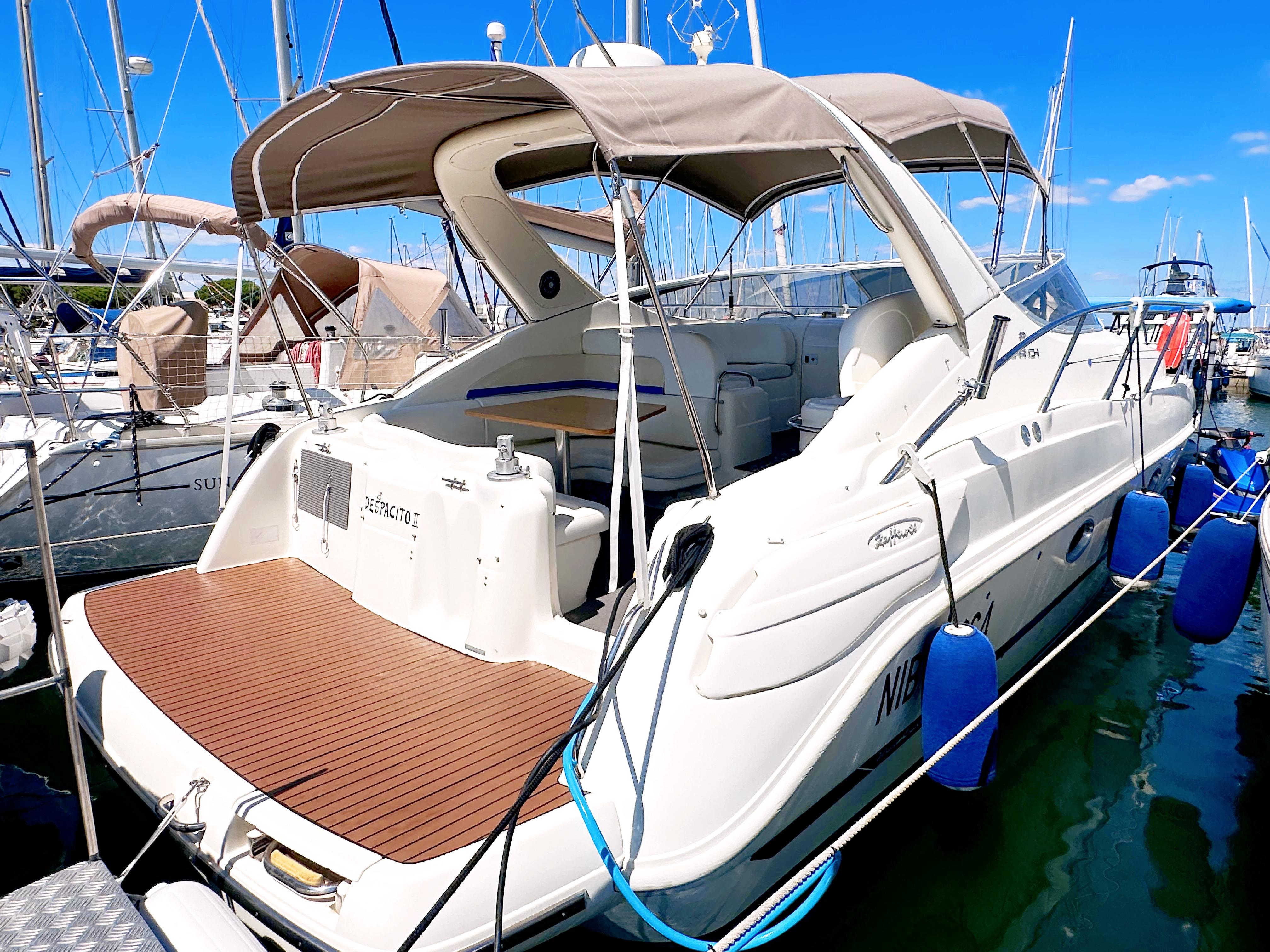 Cranchi Zaffiro 34 2001 Cranchi Zaffiro 34 yacht docked in marina, featuring spacious deck and canopy.