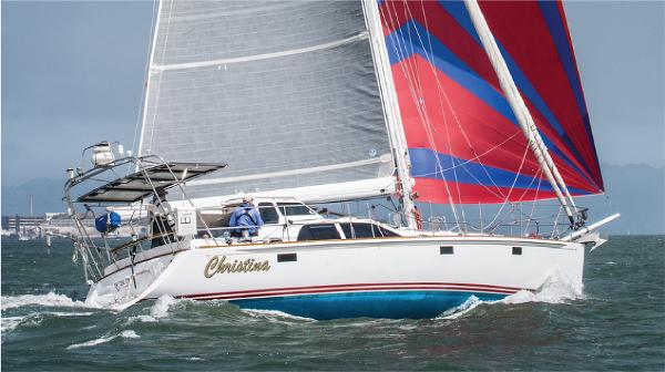 Morris 486 Sailing yacht "Christina" on the water, featuring vibrant red and blue sails.