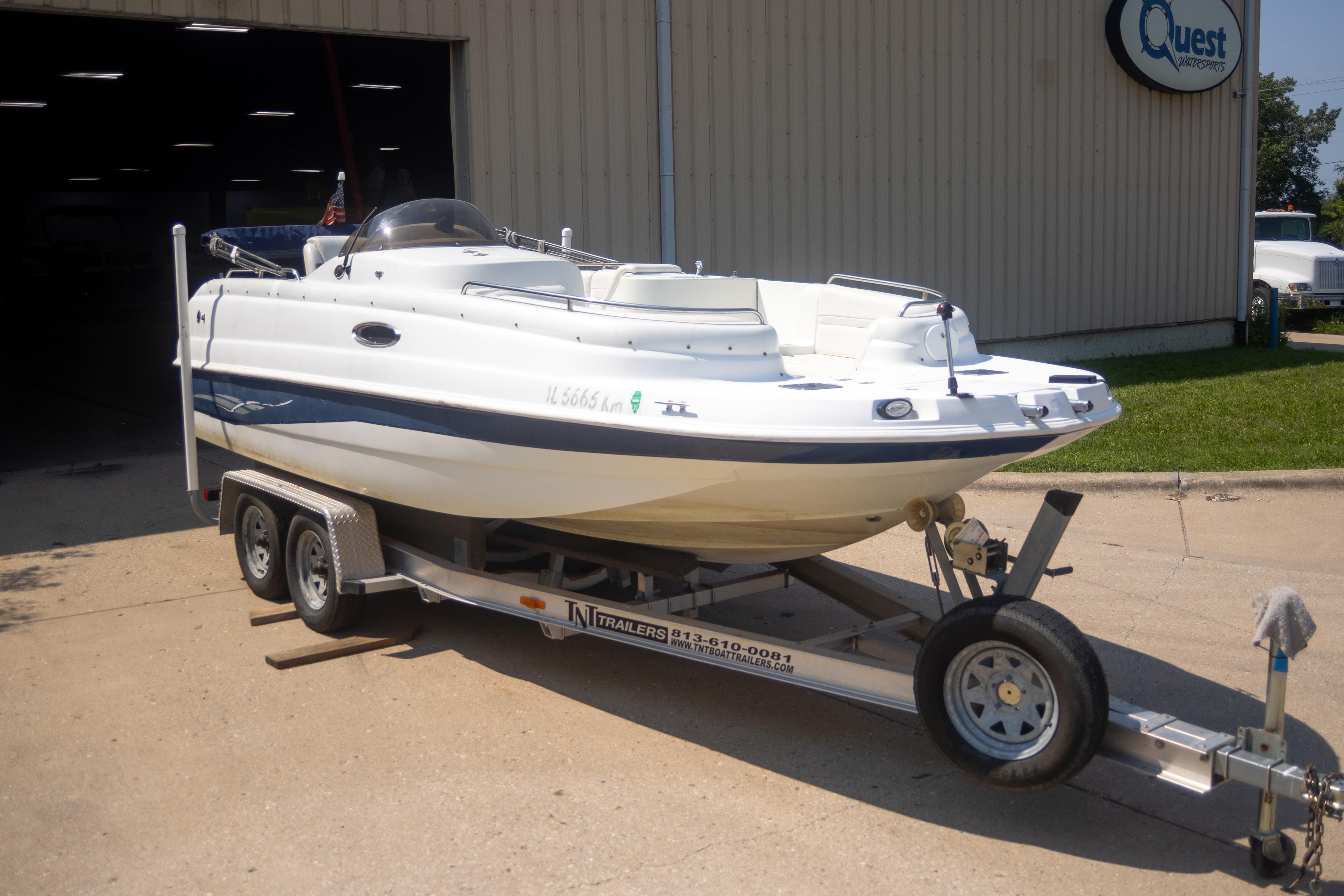 Starcraft AUORA 229 STEP CC DECK 2002 Starcraft AUORA 229 STEP CC DECK boat on trailer outside a building.