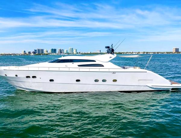 Tecnomar 90 Luxury Tecnomar 90 yacht cruising on open water, city skyline in background.