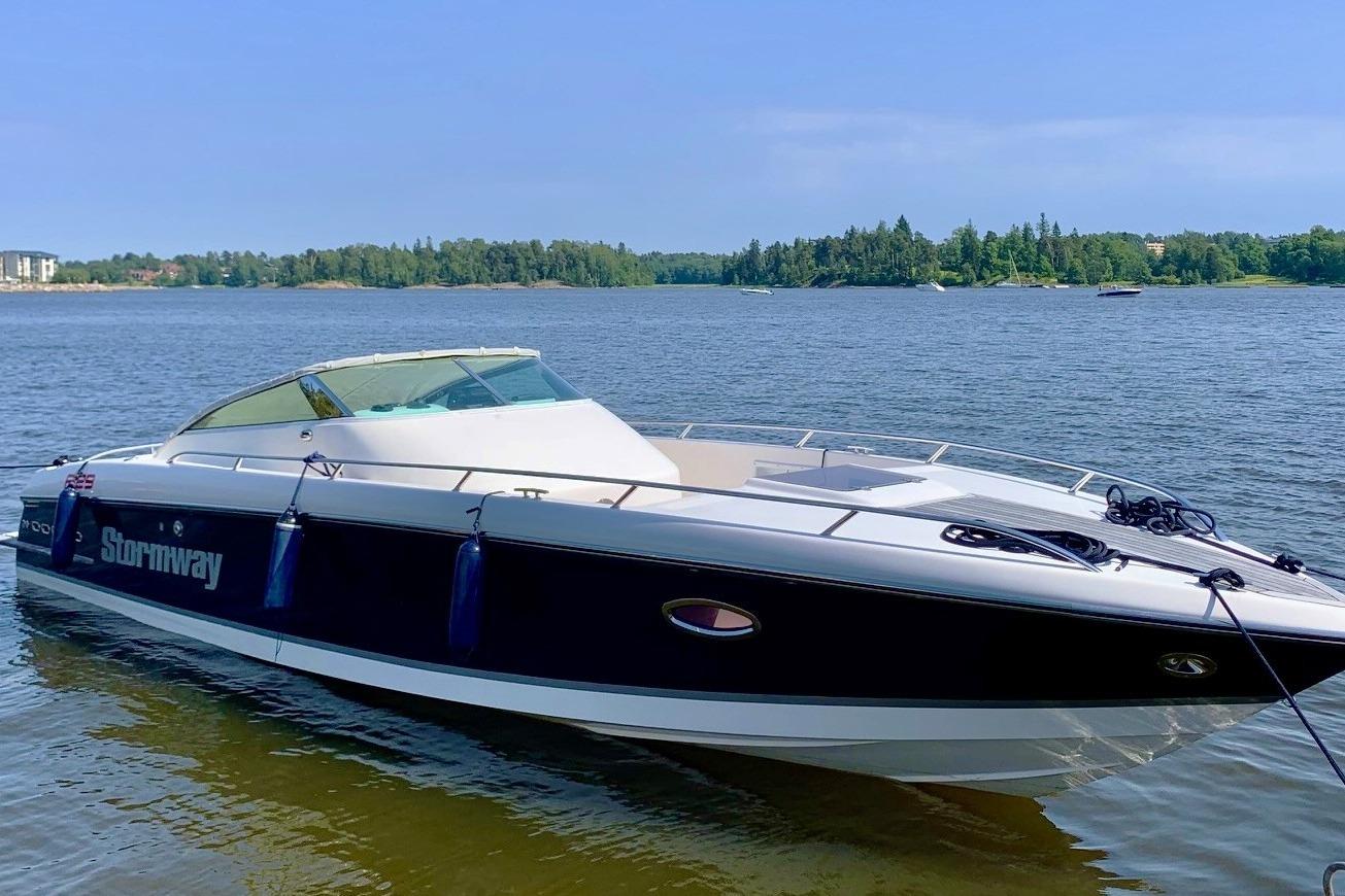 Custom Stormway F29 2008 Stormway F29 boat on a serene lake with lush green shoreline.