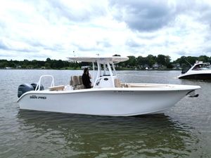 Sea Pro 259 DLX 2023 Sea Pro 259 DLX boat on calm water under cloudy sky.