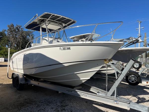 Boston Whaler 240 Outrage 2004 Boston Whaler 240 Outrage boat on trailer, sunny day, clear blue sky.