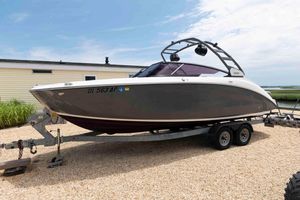 Yamaha Boats 252S 2021 Yamaha Boats 252S on trailer, parked outdoors near a house, under a clear sky.