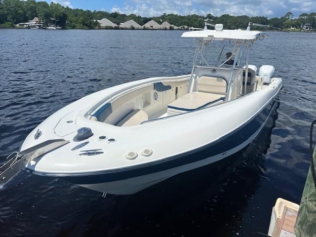 Hydra-Sports Vector 3300 CC 2006 Hydra-Sports Vector 3300 CC boat on calm water, featuring sleek design and spacious deck.