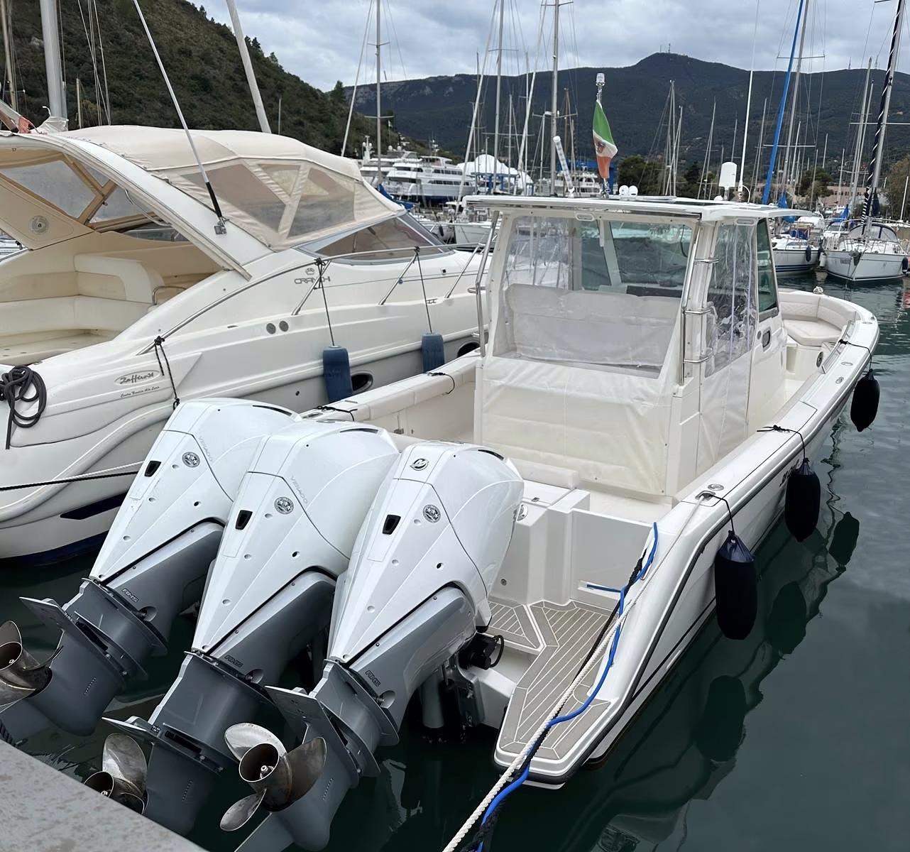 3B Craft 330 CC 2023 3B Craft 330 CC boat docked in marina with triple outboard engines.