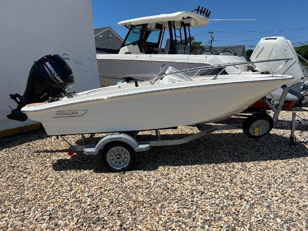 Boston Whaler 130 Super Sport 2024 Boston Whaler 130 Super Sport boat on trailer, parked on gravel.