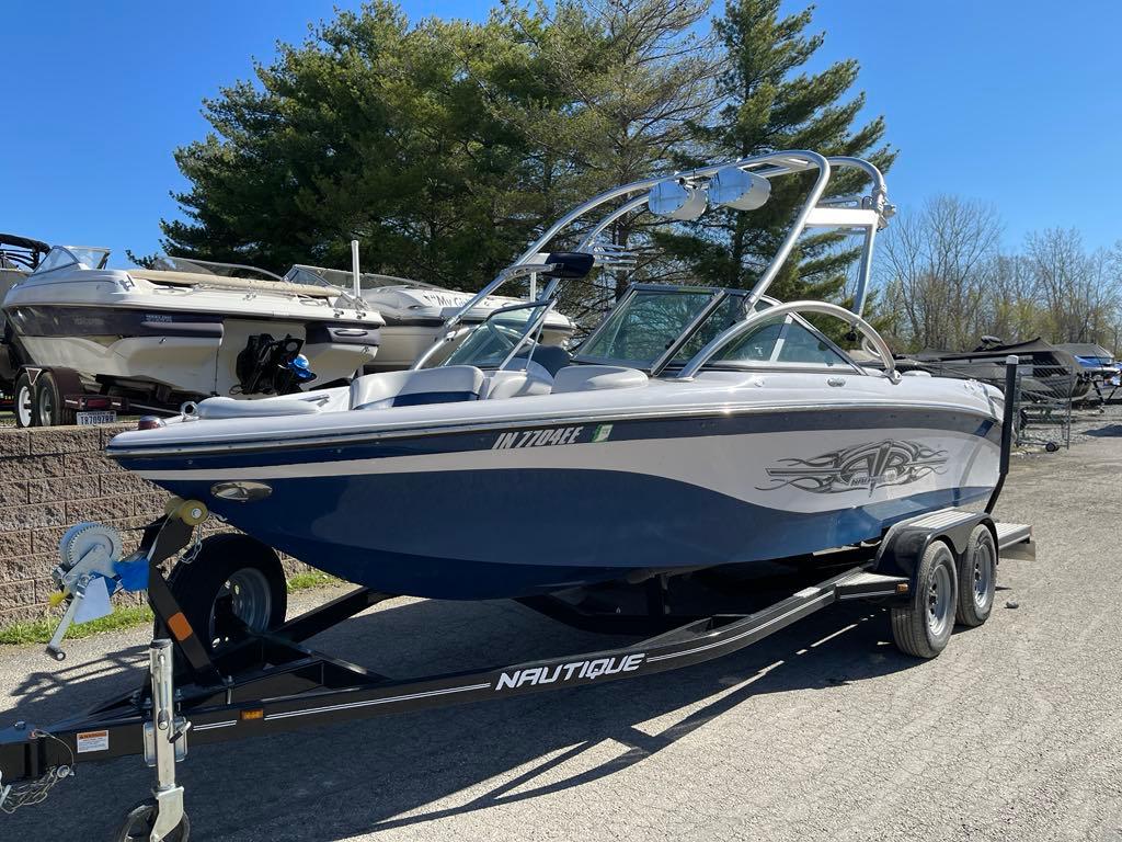 Nautique Crossover 211 2008 Nautique Crossover 211 boat on trailer, parked outdoors.