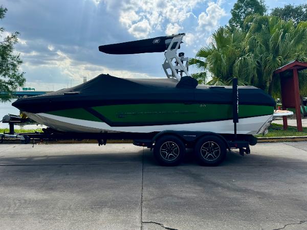 Nautique Super Air Nautique GS20 2017 Nautique Super Air Nautique GS20 boat on trailer, parked near palm trees.