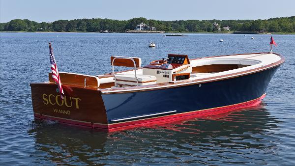 Boca Grande 26 Classic 1989 Boca Grande 26 boat on calm water, featuring wooden accents and American flag.