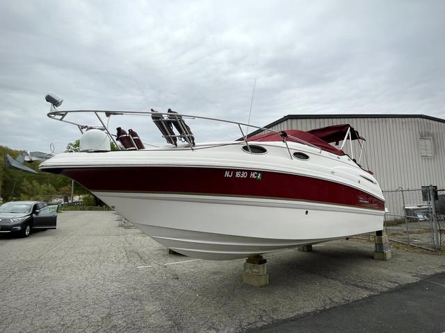 Chaparral Signature 260 2004 Chaparral Signature 260 boat with red accents, docked on land.
