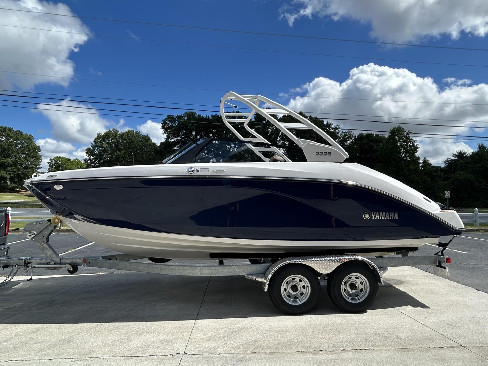 Yamaha Boats 222 S 2024 Yamaha Boats 222 S on trailer under blue sky with clouds.