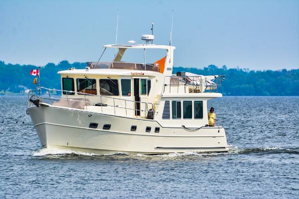 North Pacific 49 Pilothouse 2016 North Pacific 49 Pilothouse yacht cruising on a calm lake.