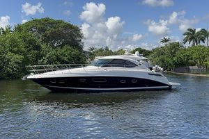 Sea Ray 470 Sundancer 2012 Sea Ray 470 Sundancer yacht on a serene waterway, surrounded by lush greenery.